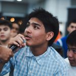 Programs 36 Young man speaking into microphone at church event in Subic Bay.