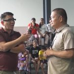 Programs 53 Two men engaged in conversation during a community event at Subic Bay Baptist Ministries.