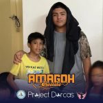 Programs 44 Two young boys with a woman, smiling, indoors at Subic Bay Baptist Ministries.