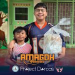 Programs 47 Two children smiling, holding a gift bag at Subic Bay Baptist Ministries event.