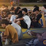 Programs 14 A man and boys praying outdoors during a religious gathering at Subic Bay Baptist Ministries.